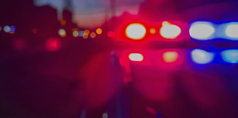 Flashing police car lights at night