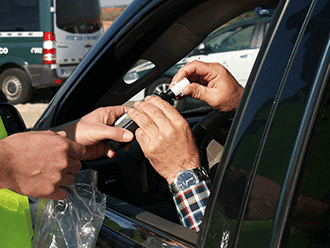 Person in car taking the breathalyzer to take test